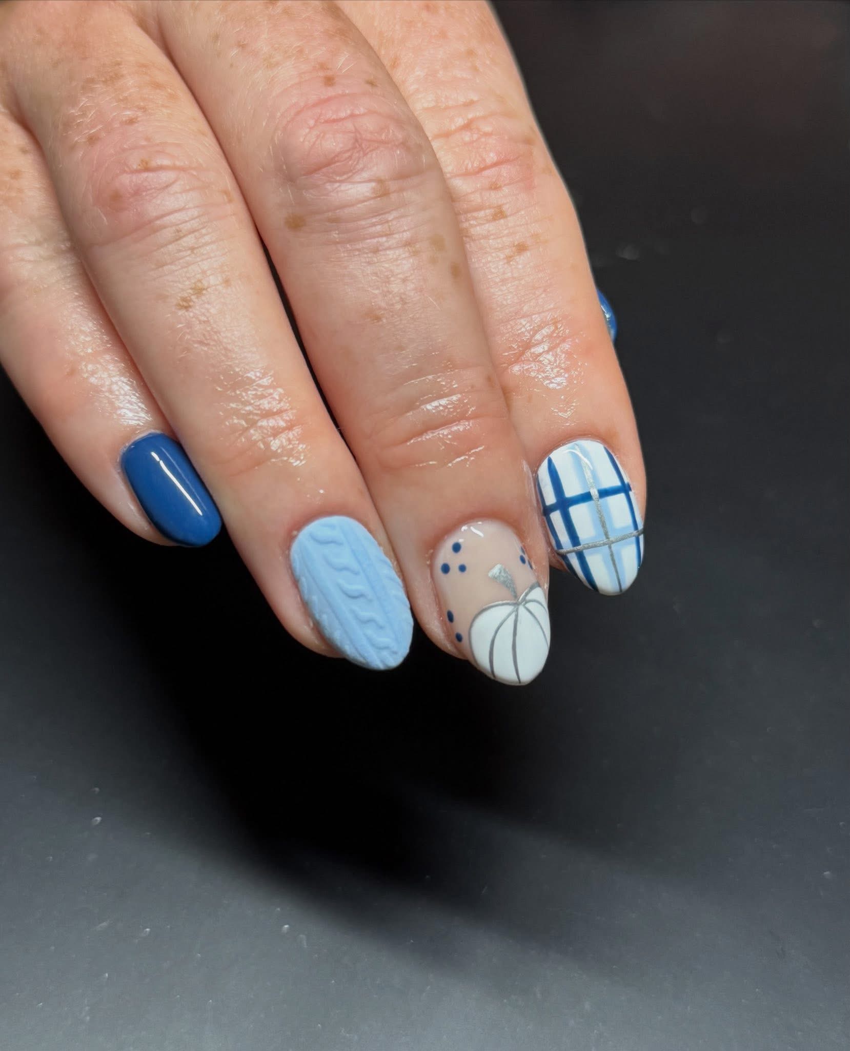 Blue and white nail art with cable-knit texture and plaid patterns