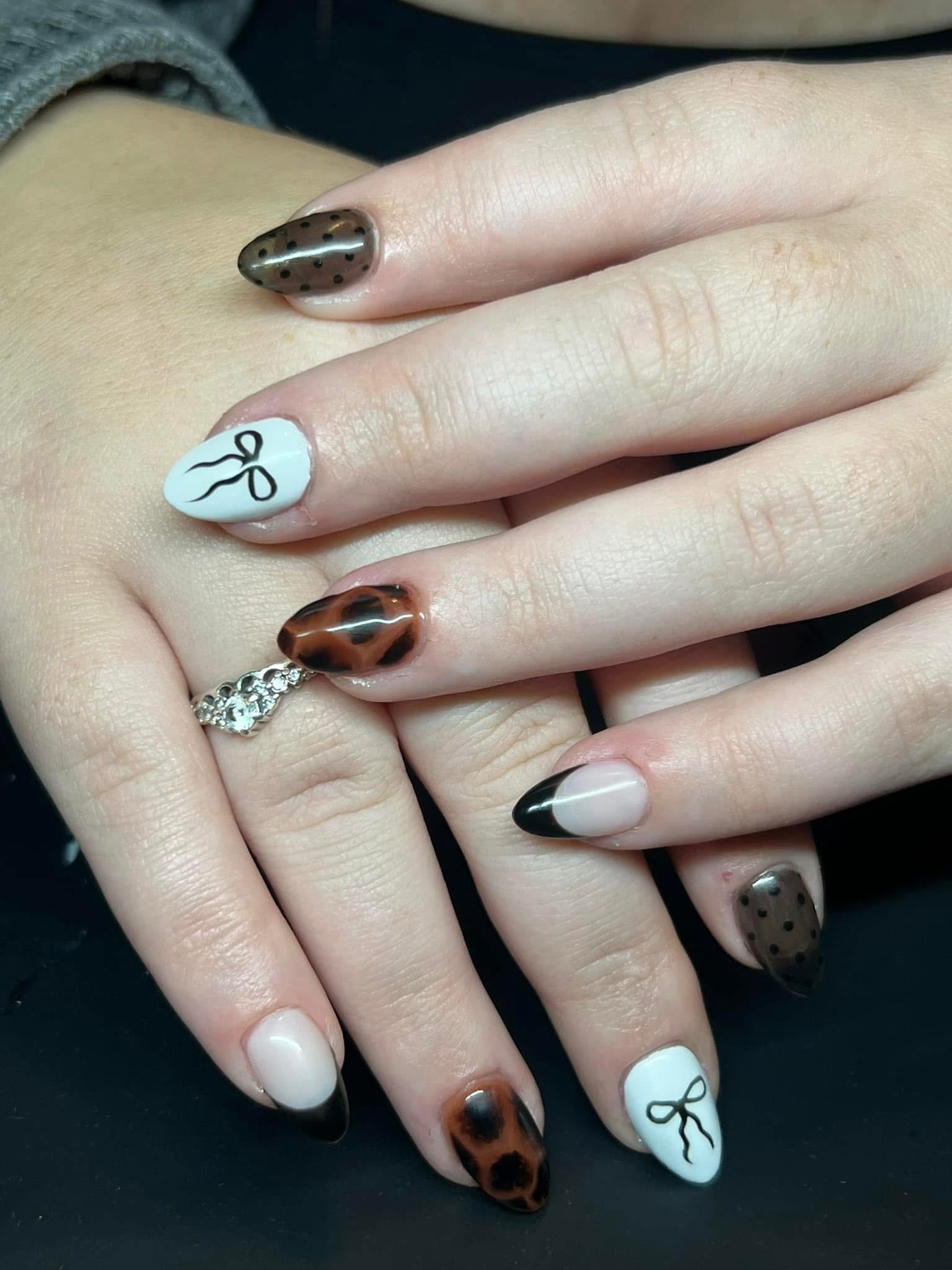 Leopard print nails with bow designs and polka dots