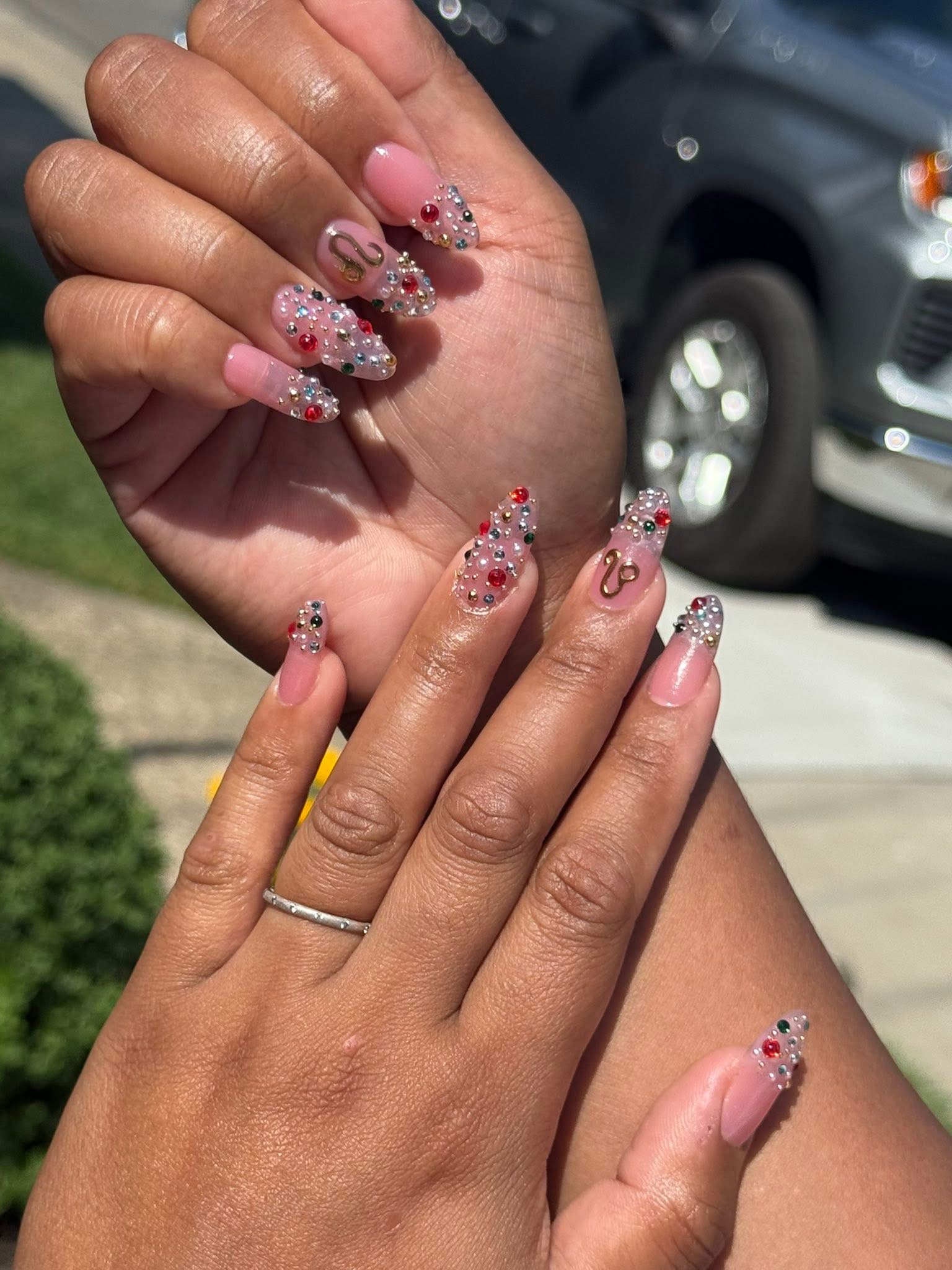 Rhinestone embellished nails with gold charm accents