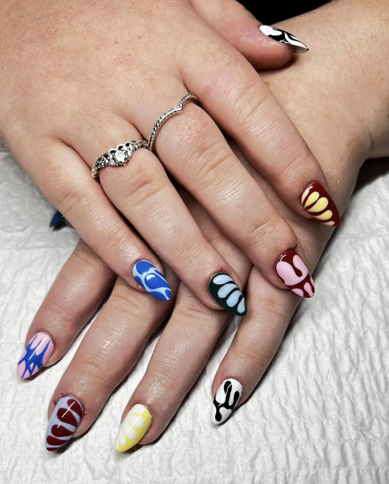 Long stiletto nails with vibrant colorful drip designs